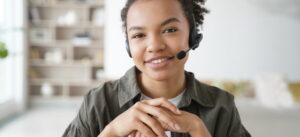 Virtual assistant. Young afro woman in headset is operator of client support service from home.